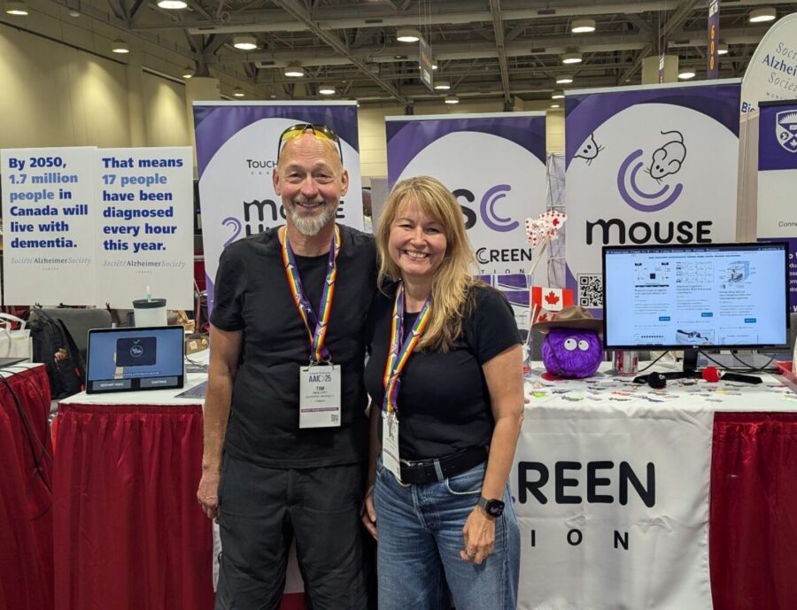 Tim Bussey and Lisa Saksida in front of the Touchscreen Cognition booth at AAIC2025